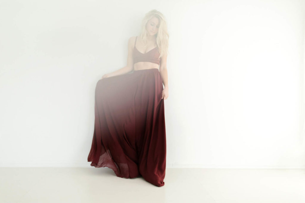 Chicago bridal boudoir photography offered by Boudoir by Elle captures dreamy boudoir image of a woman in a red dress 