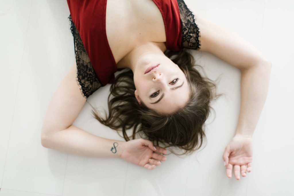 overhead photo of woman laying on floor portrait 