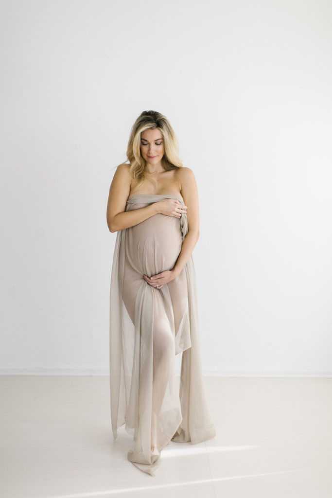 woman looking down during pregnancy session