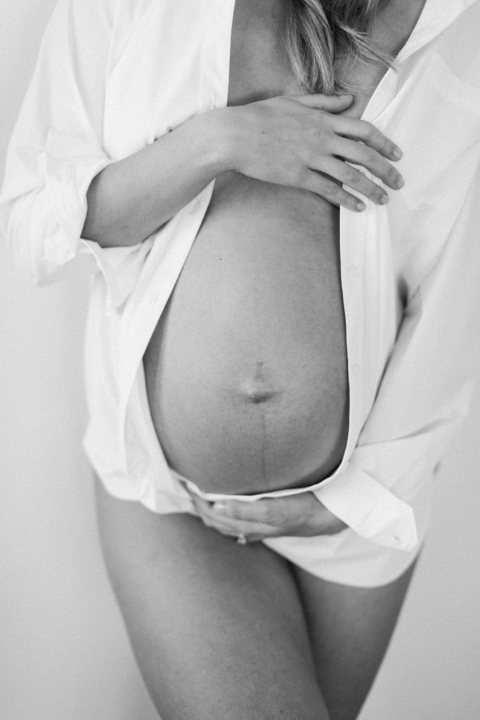 pregnancy photo session black and white image of belly