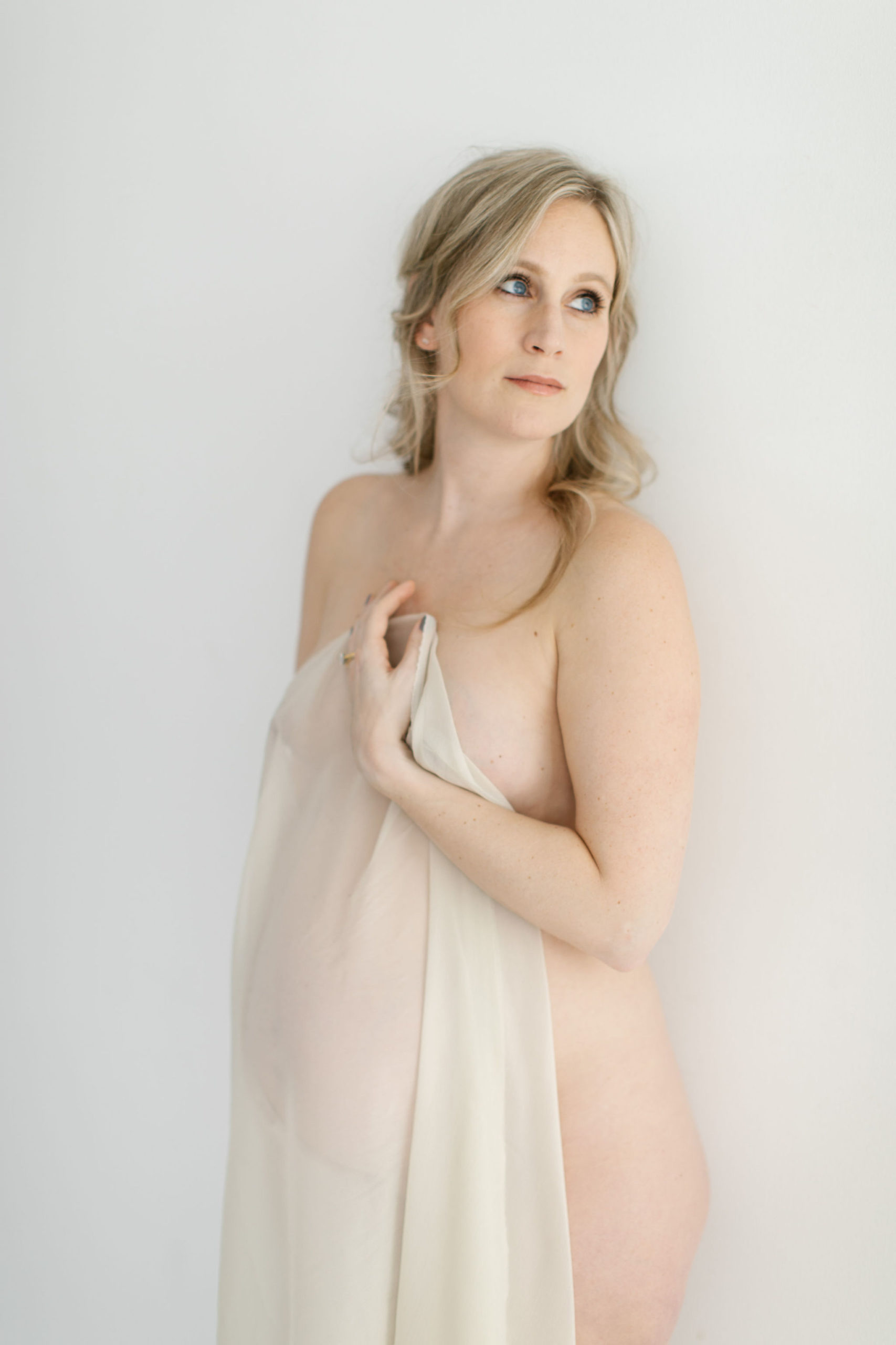 beautiful portrait of a woman gazing to the side during maternity photo session