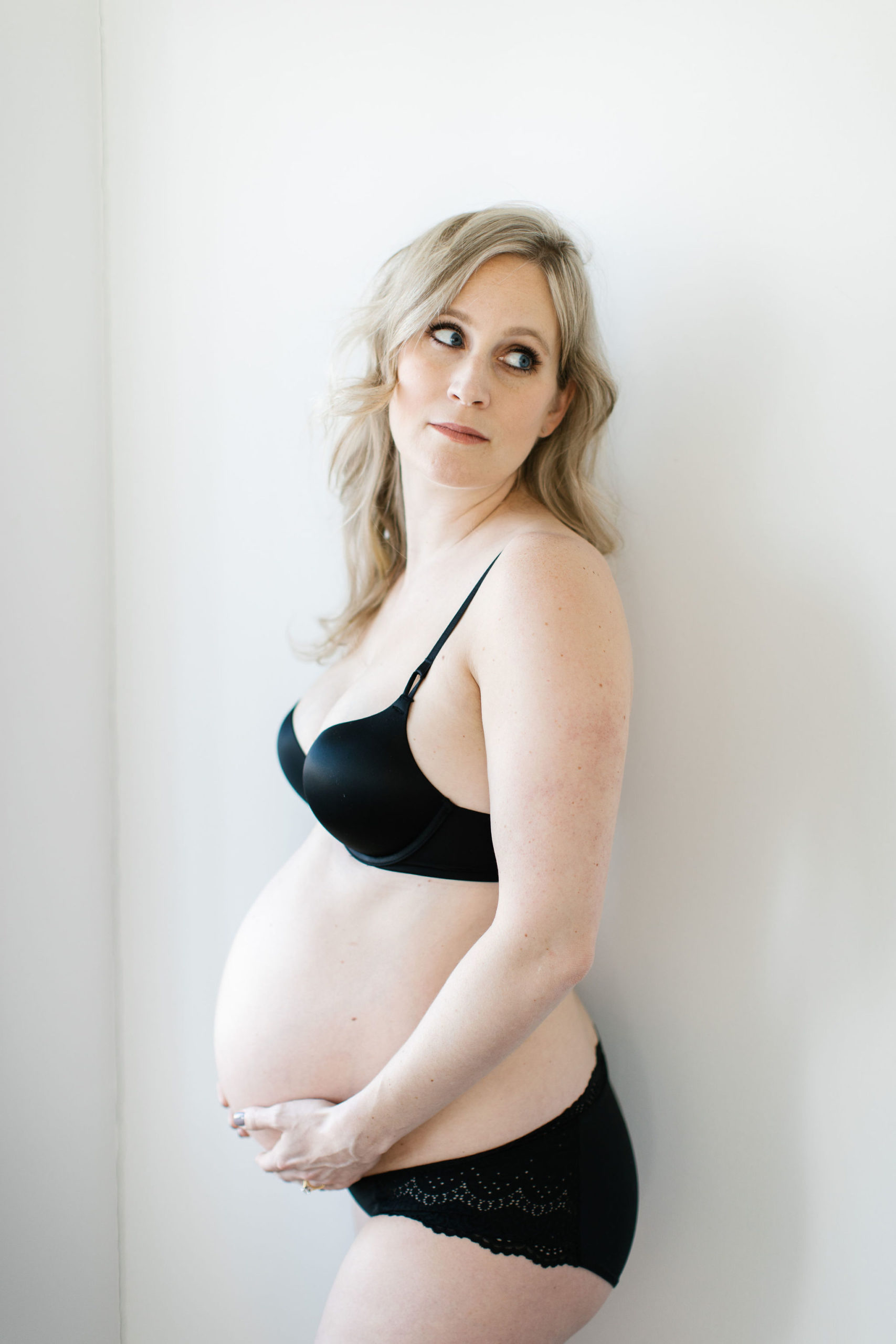 woman gazing off to the side during unique maternity session
