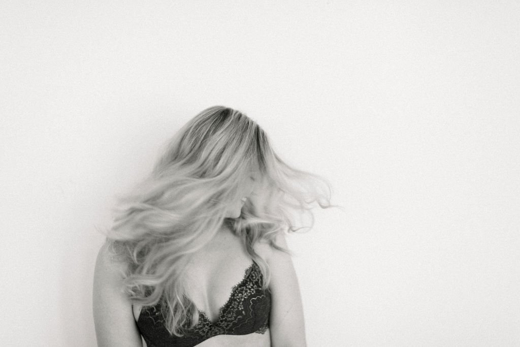 confident woman shaking her hair black and white image